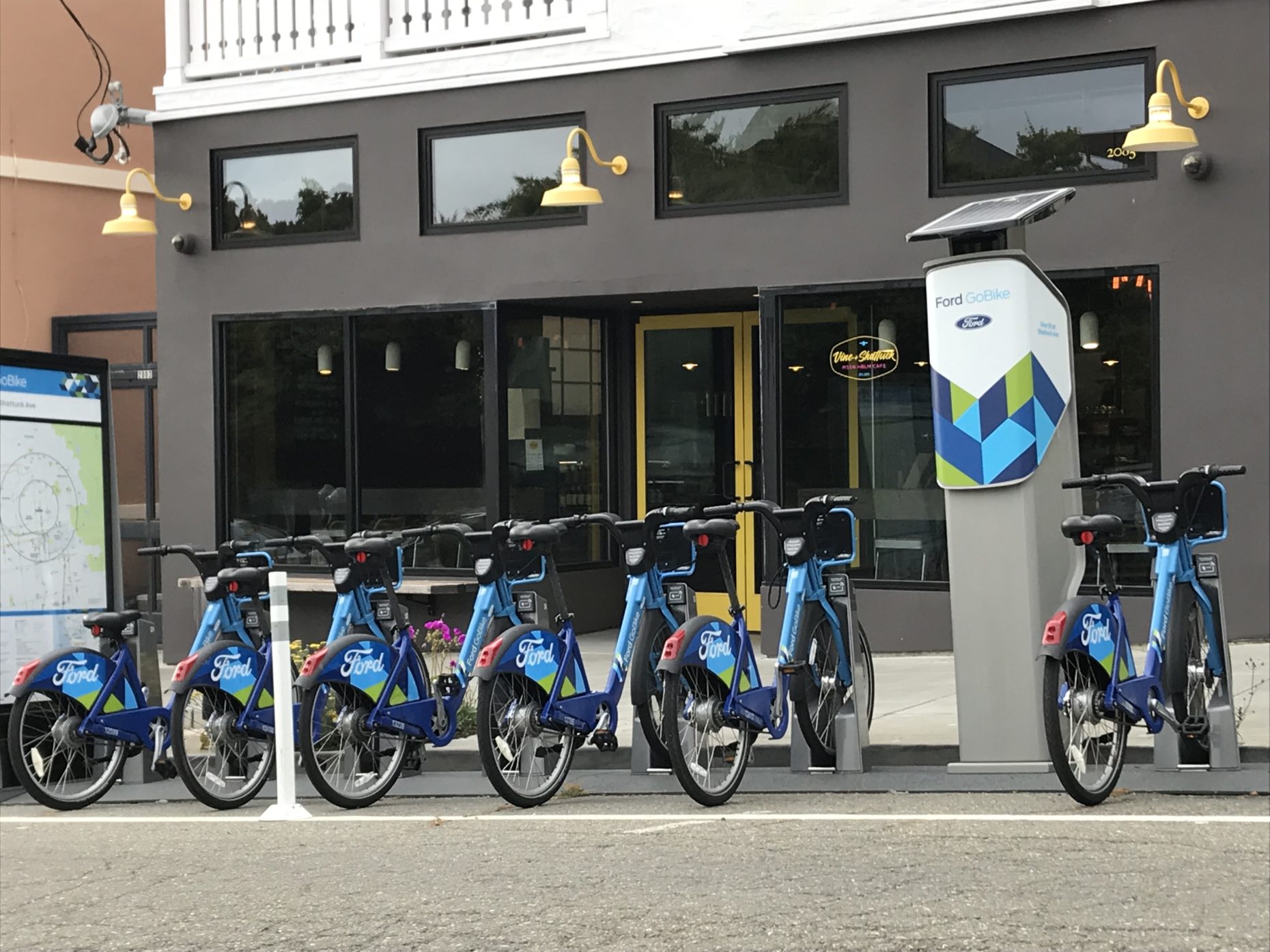 Blue bicycles at bike rental self-serve stand